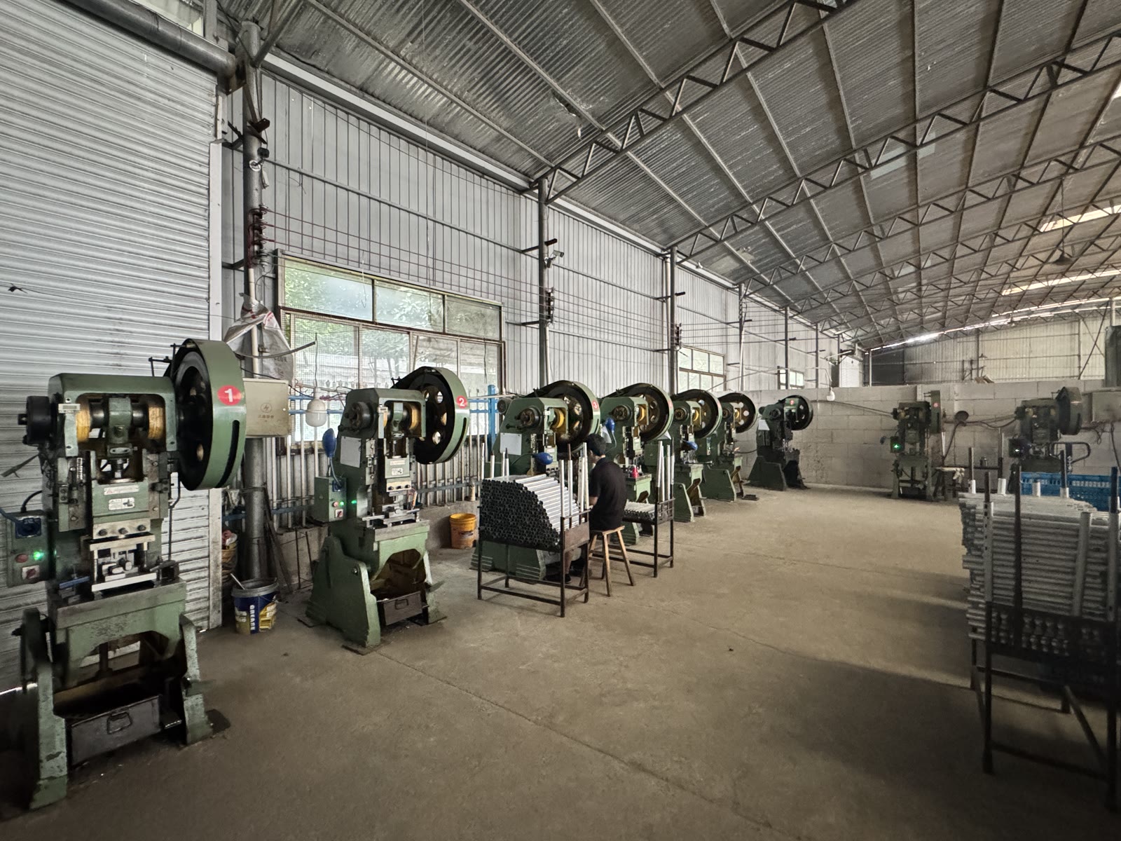 Metalworking workshop with production presses for scooter components